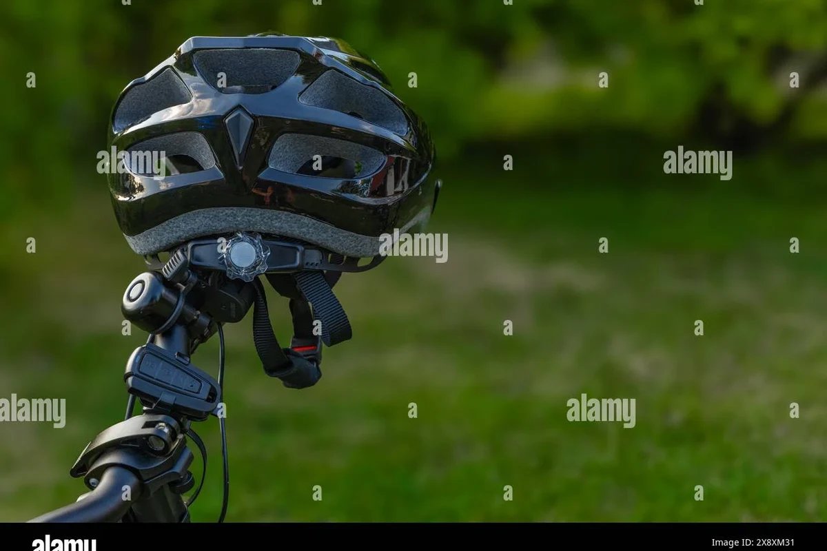 Cyclist choosing a properly fitted bike helmet with adjustable straps and safety features