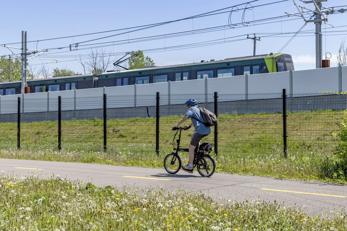 E-bike rider measuring lock fit around frame and bike rack